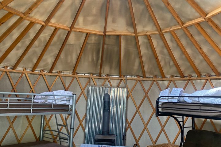 a wooden bench sitting on top of a metal fence