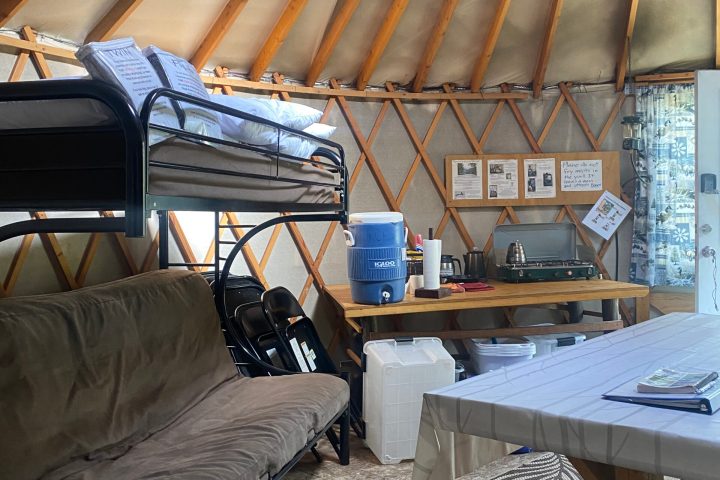 a bedroom with a bed and a chair in a room