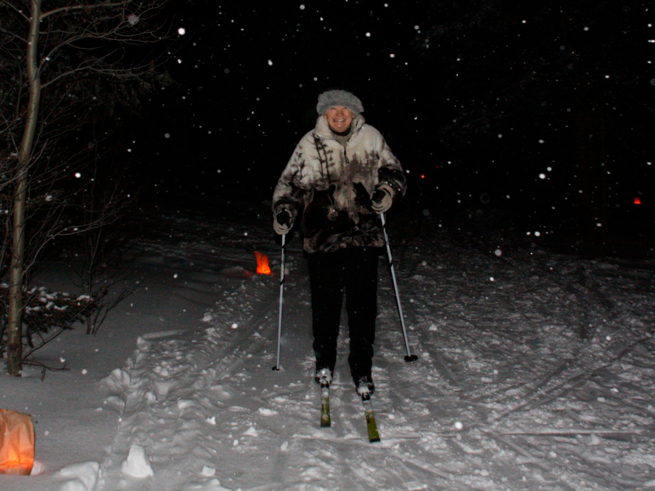 a man riding skis down a snow covered slope