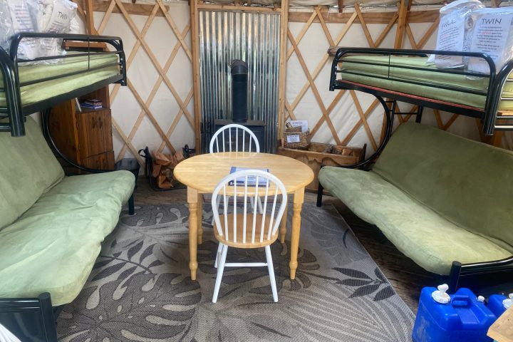 a bedroom with a bed and a chair in a room