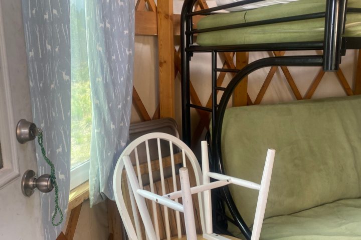 a chair sitting in front of a wooden table