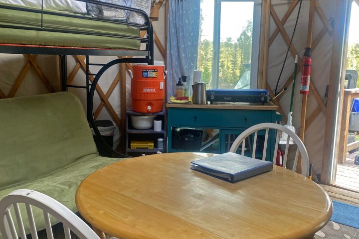 a chair sitting in front of a wooden table