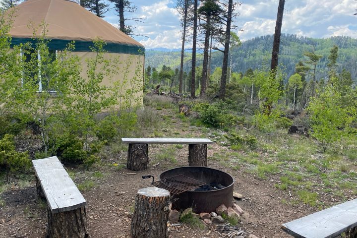 a couple of lawn chairs sitting on top of a picnic table