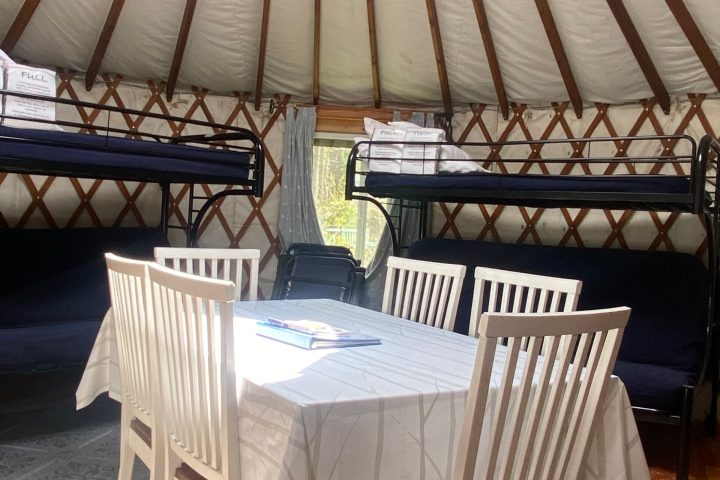an umbrella sitting on top of a wooden chair