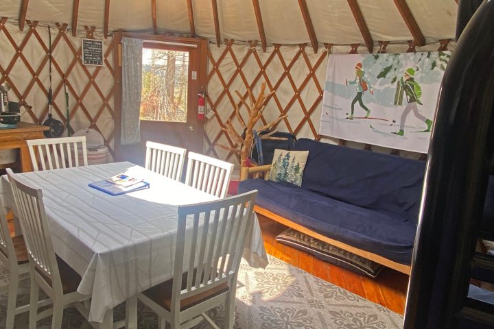 a bedroom with a bed and a chair in a room