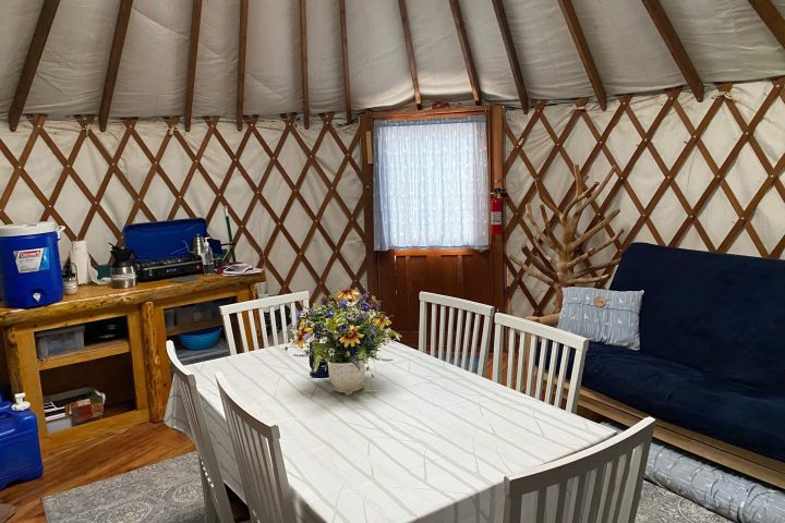 a bedroom with a bed and a chair in a room