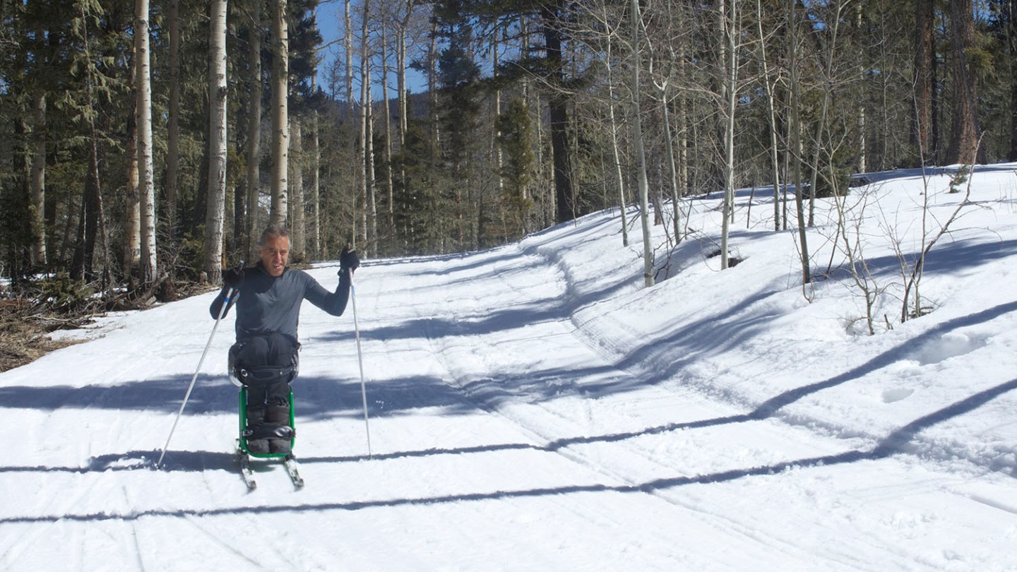 a person riding skis down a snow covered slope