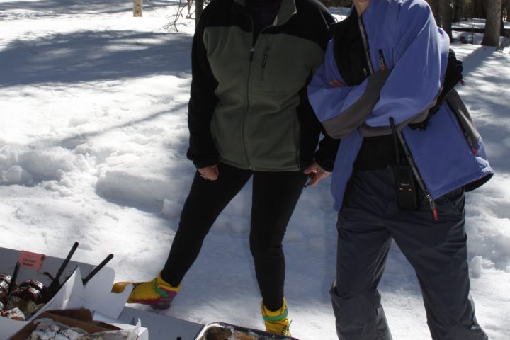 a group of people posing for a picture in the snow