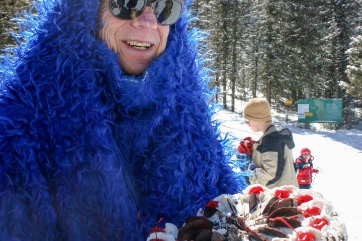 a person holding a cake in the snow