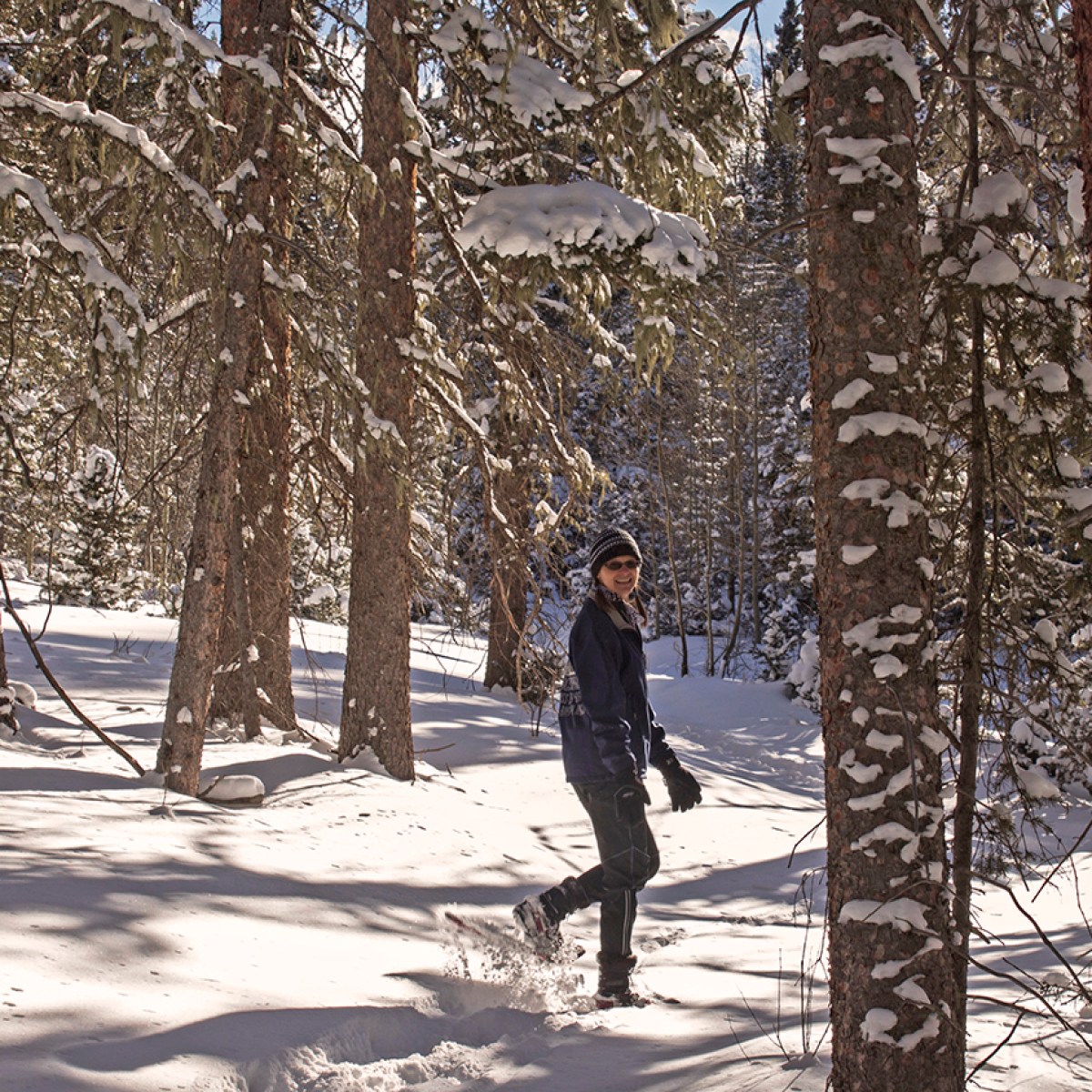 a man riding skis down a snow covered slope