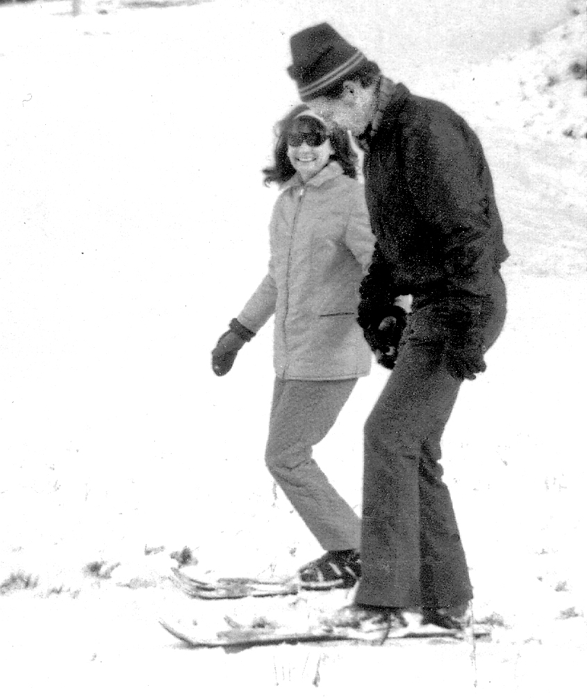 a man riding a snowboard down a snow covered slope