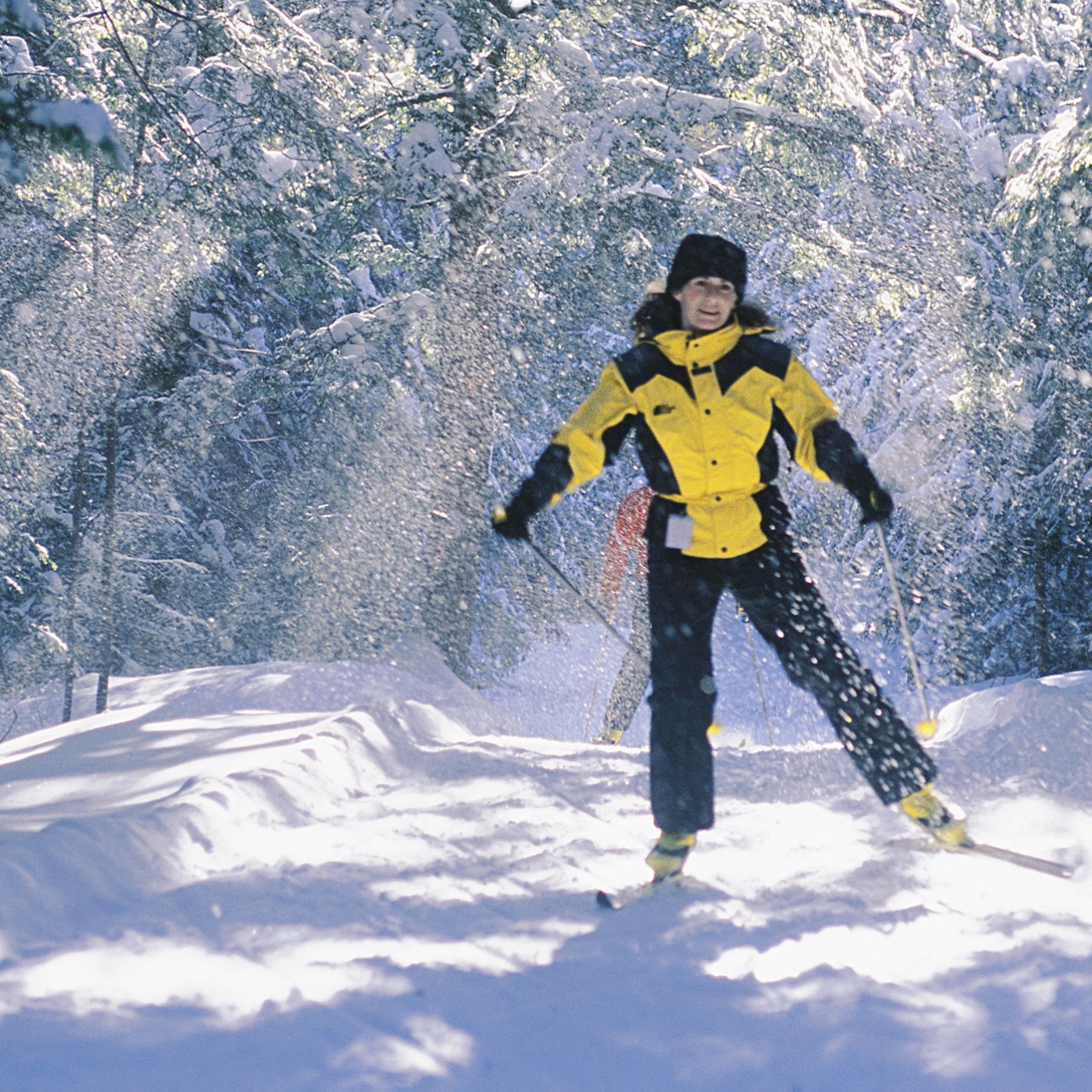 a man riding a snowboard down a snow covered slope