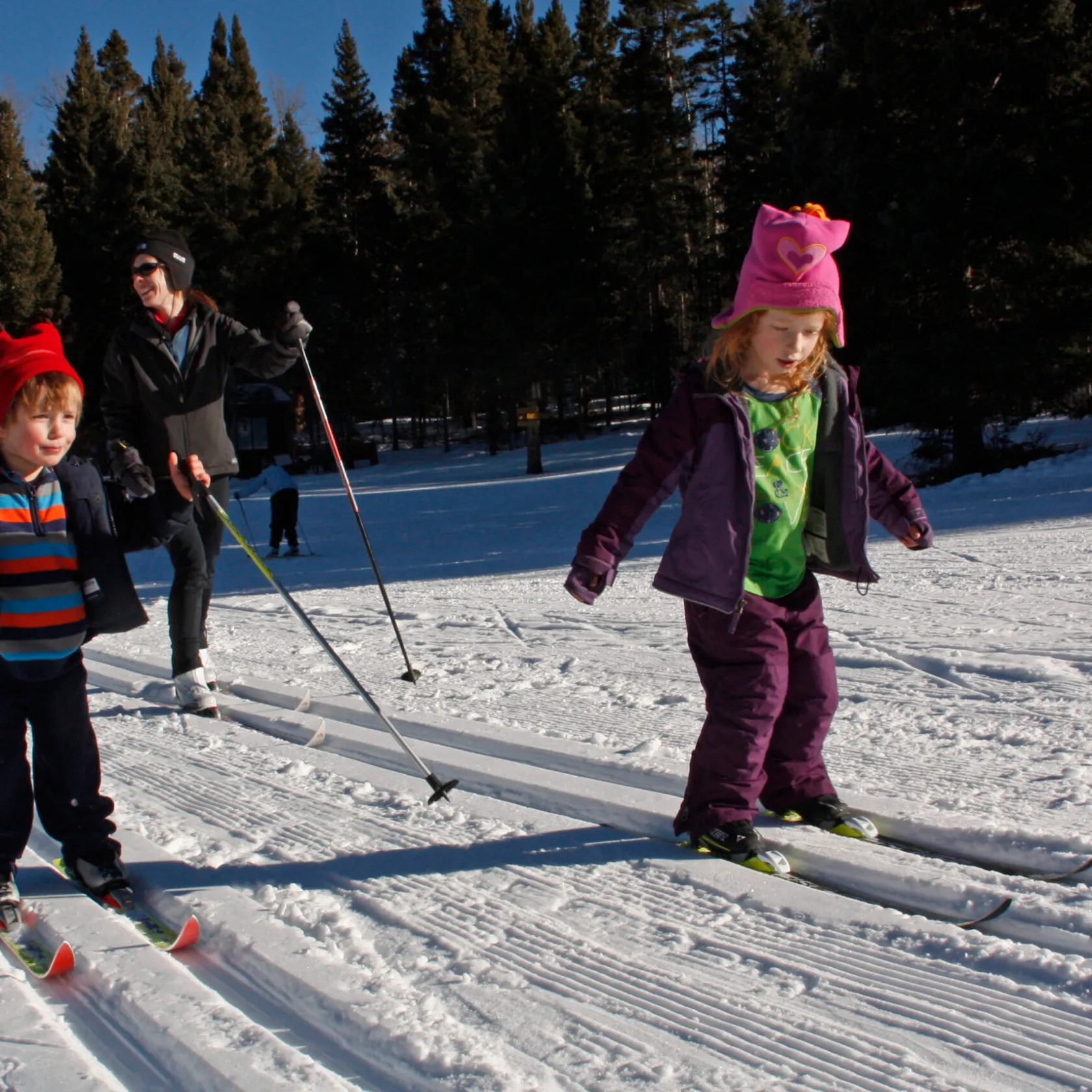 a group of people riding skis on top of a snow covered slope