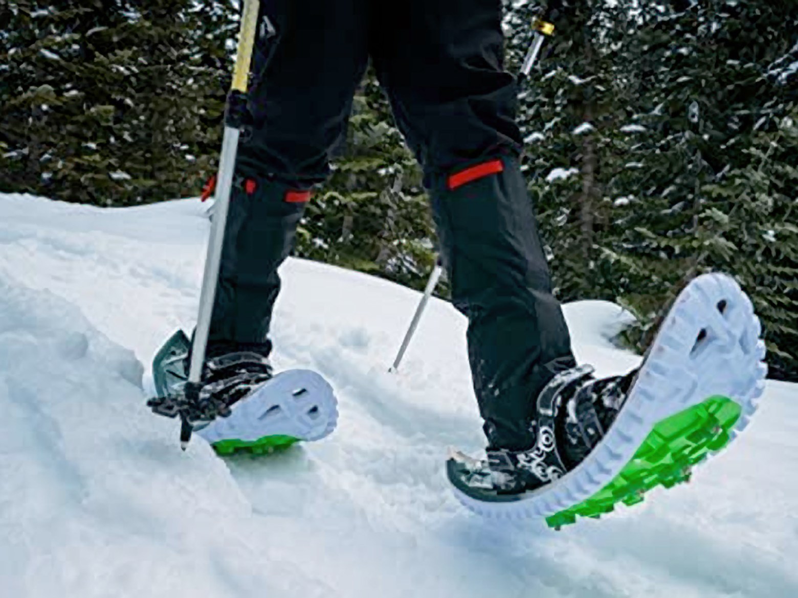 a person riding a snowboard down a snow covered slope