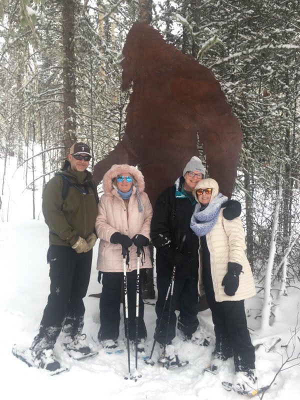a couple of people that are standing in the snow