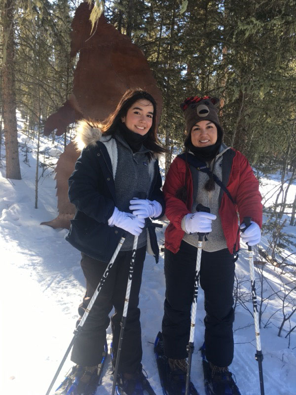 a couple of people that are standing in the snow