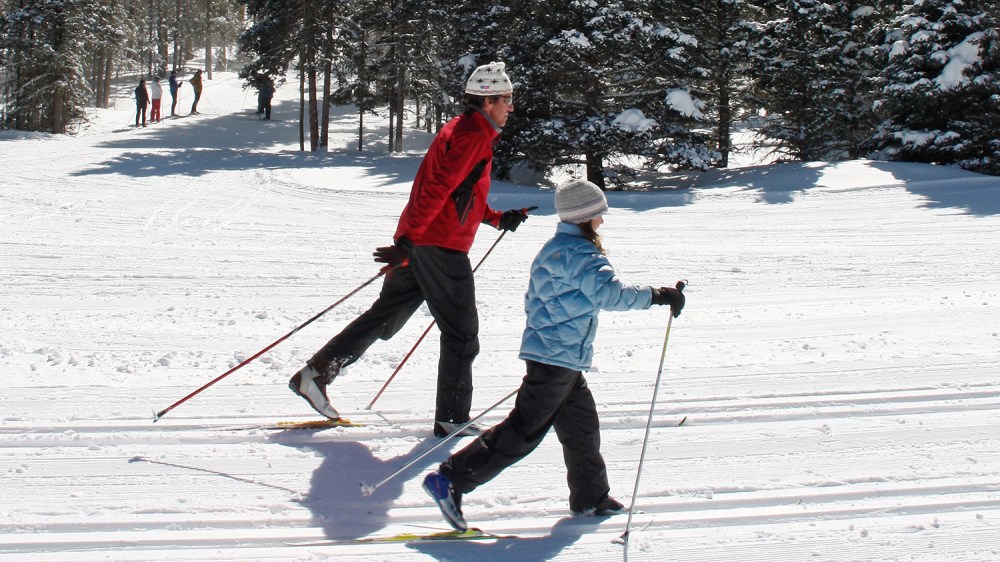 a person riding skis down a snow covered slope