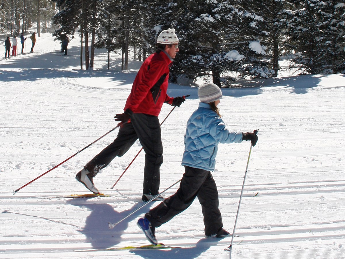 a person riding skis down a snow covered slope